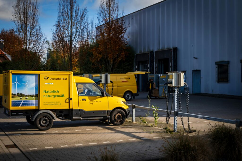 pexels photo 34726367 34726367 Deutsche Post electric delivery vans parked outdoors emphasizing sustainable logistics.